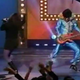Screenshot of the "Sandman" and a performer at the Apollo